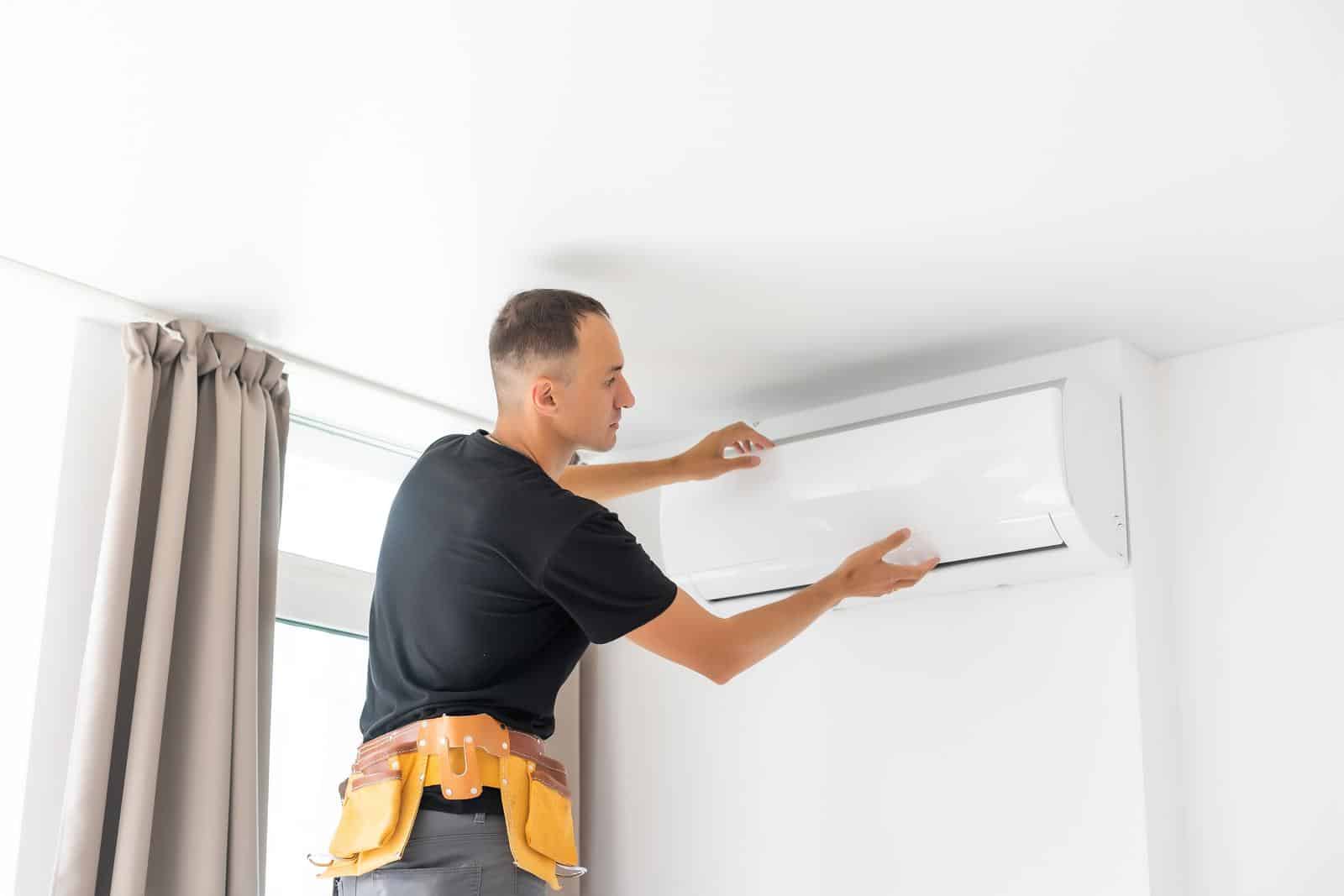 man working on air conditioning system