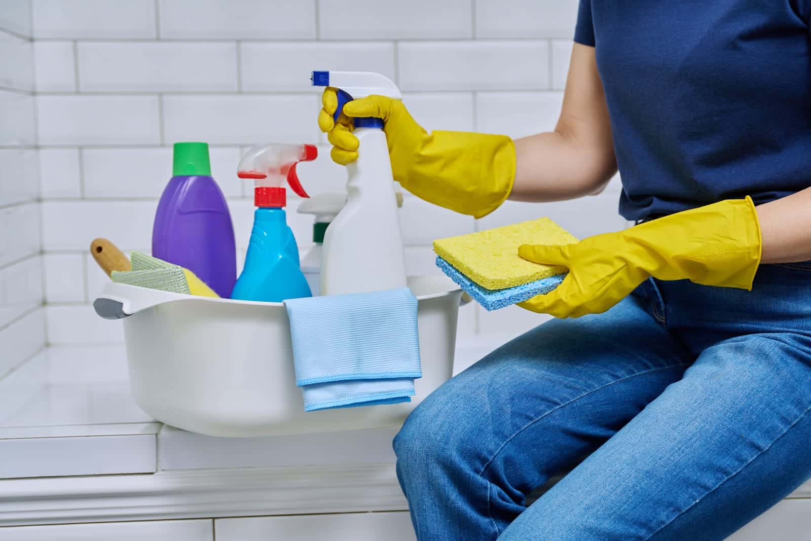 A collection of house cleaning products, including sprays, microfibre cloths, and tools